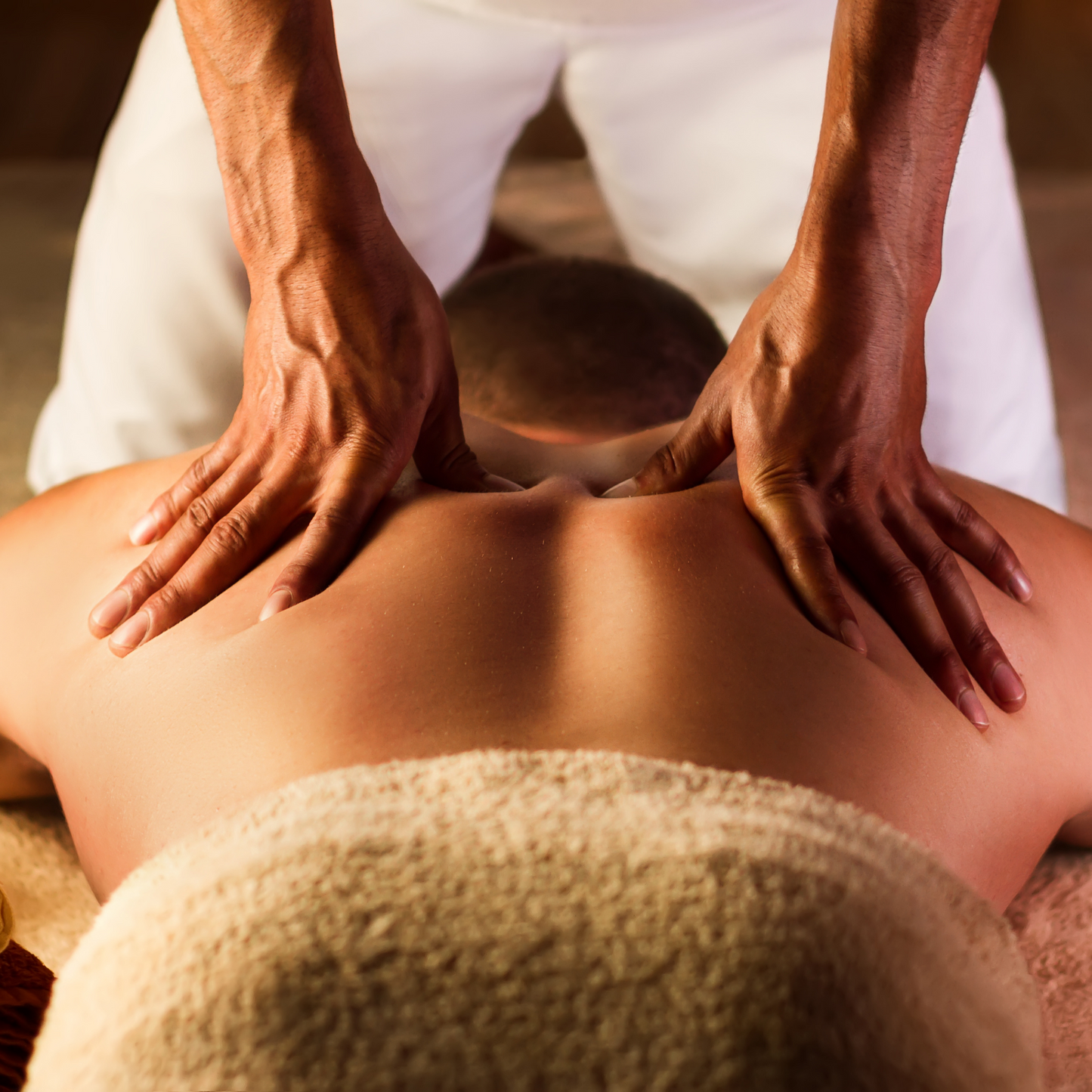 Person receiving a back massage in a spa setting
