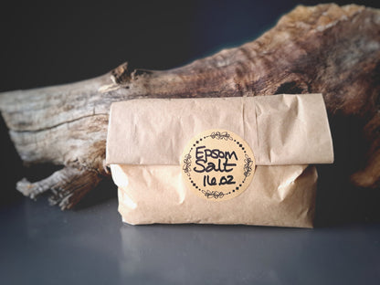 Brown paper package labeled 'Epsom Salt 14 oz' with a wooden background.