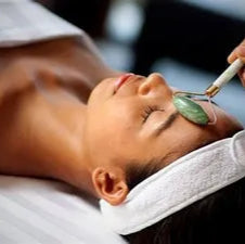 Person receiving a facial treatment with a tool on a blurred background