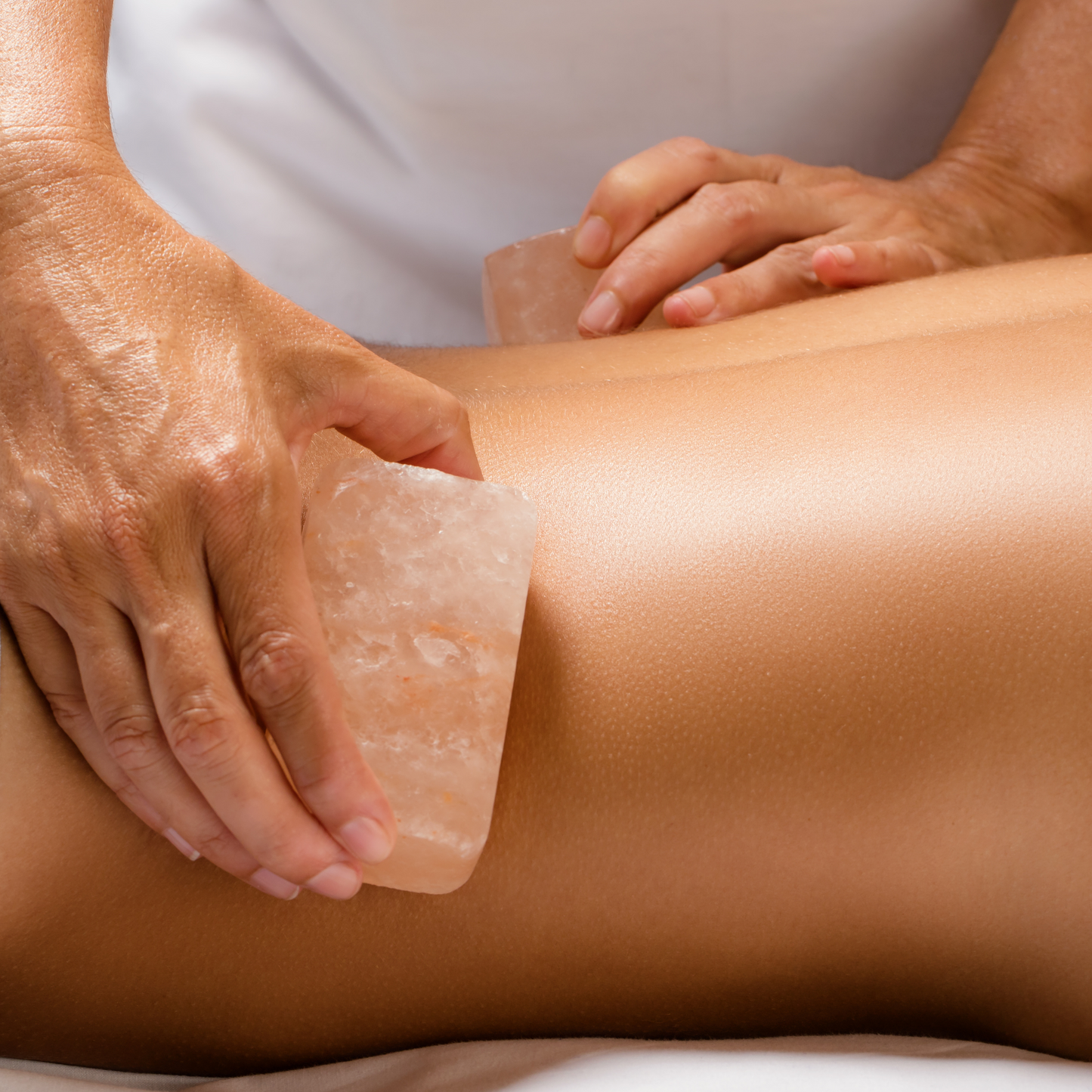 Person receiving a massage with himalayan salt stones