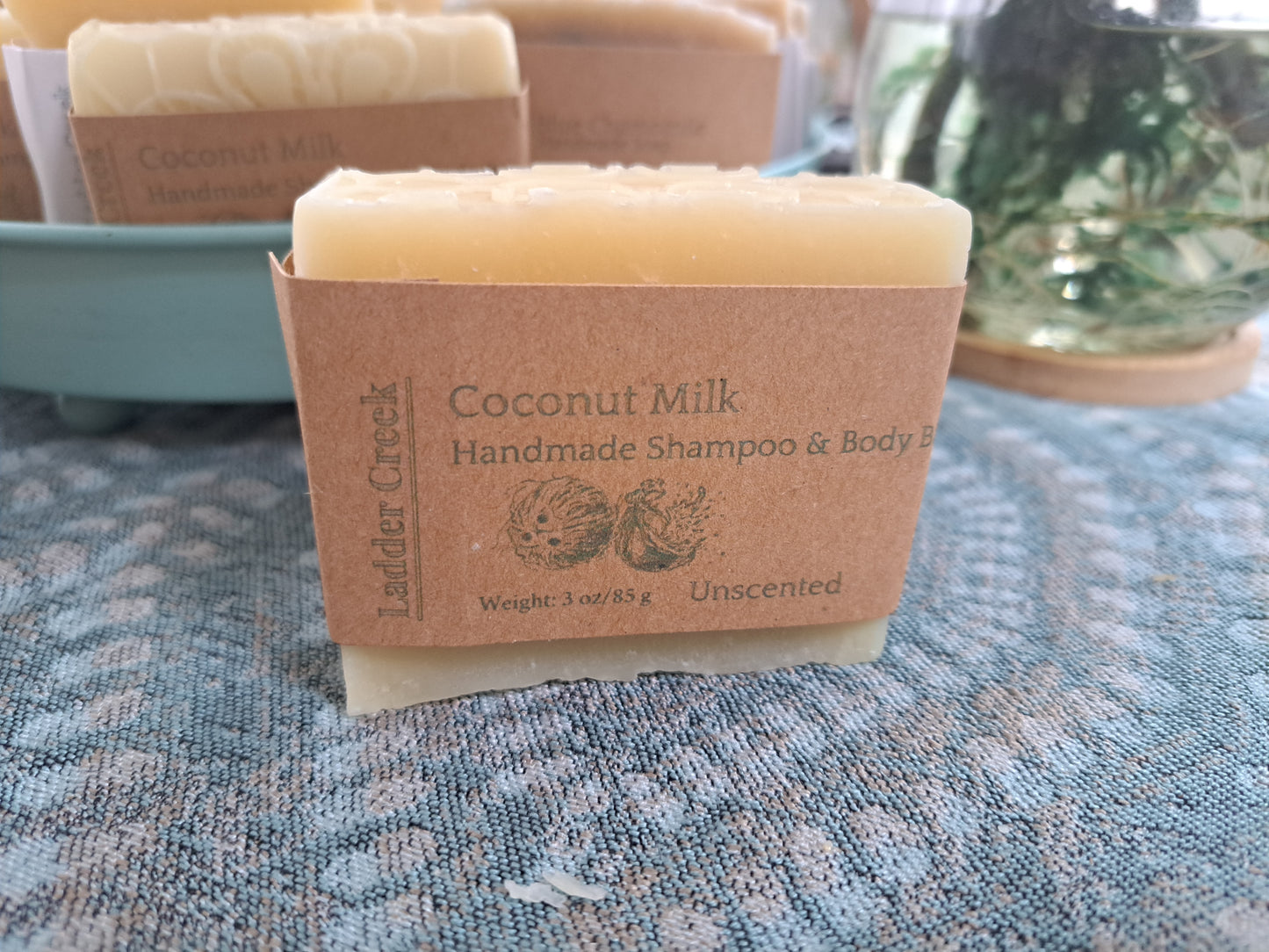 Coconut Milk handmade shampoo bar on a textured surface with 'Ladder Creek' branding.