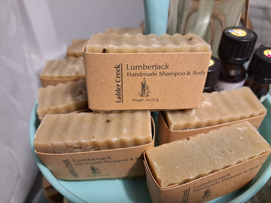 Lumberjack handmade shampoo and body bars on a blue tray with a white background