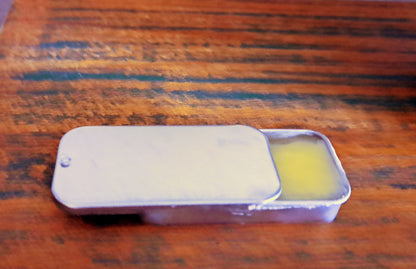 lip balm tin on wooden surface